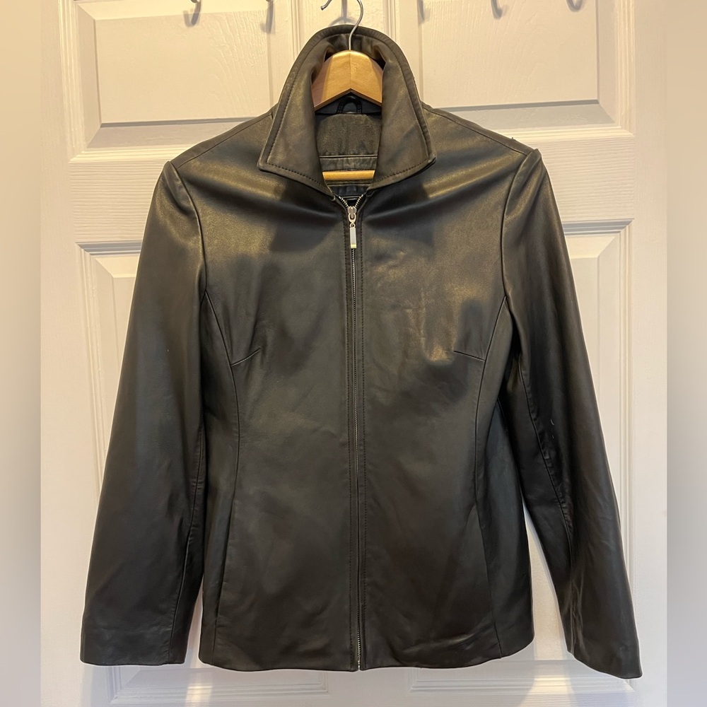 Black leather jacket new w 2 small damaged spots on left shoulder. Lined sz Med